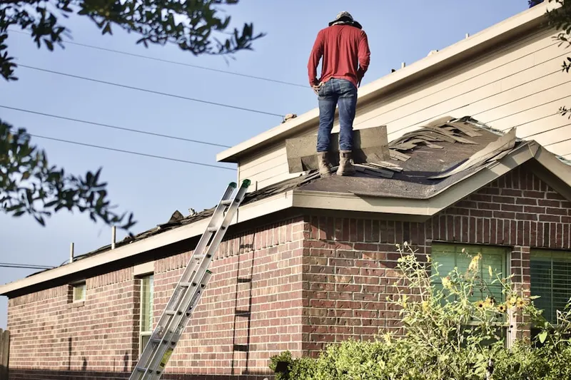 Professional roofer working on a residential roof in Country Estates
